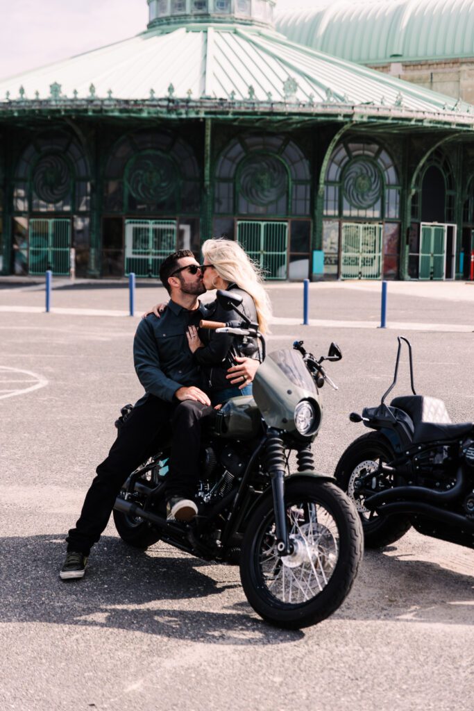 A couple sharing a playful moment during their motorcycle anniversary photoshoot in Lehigh Valley, Pennsylvania